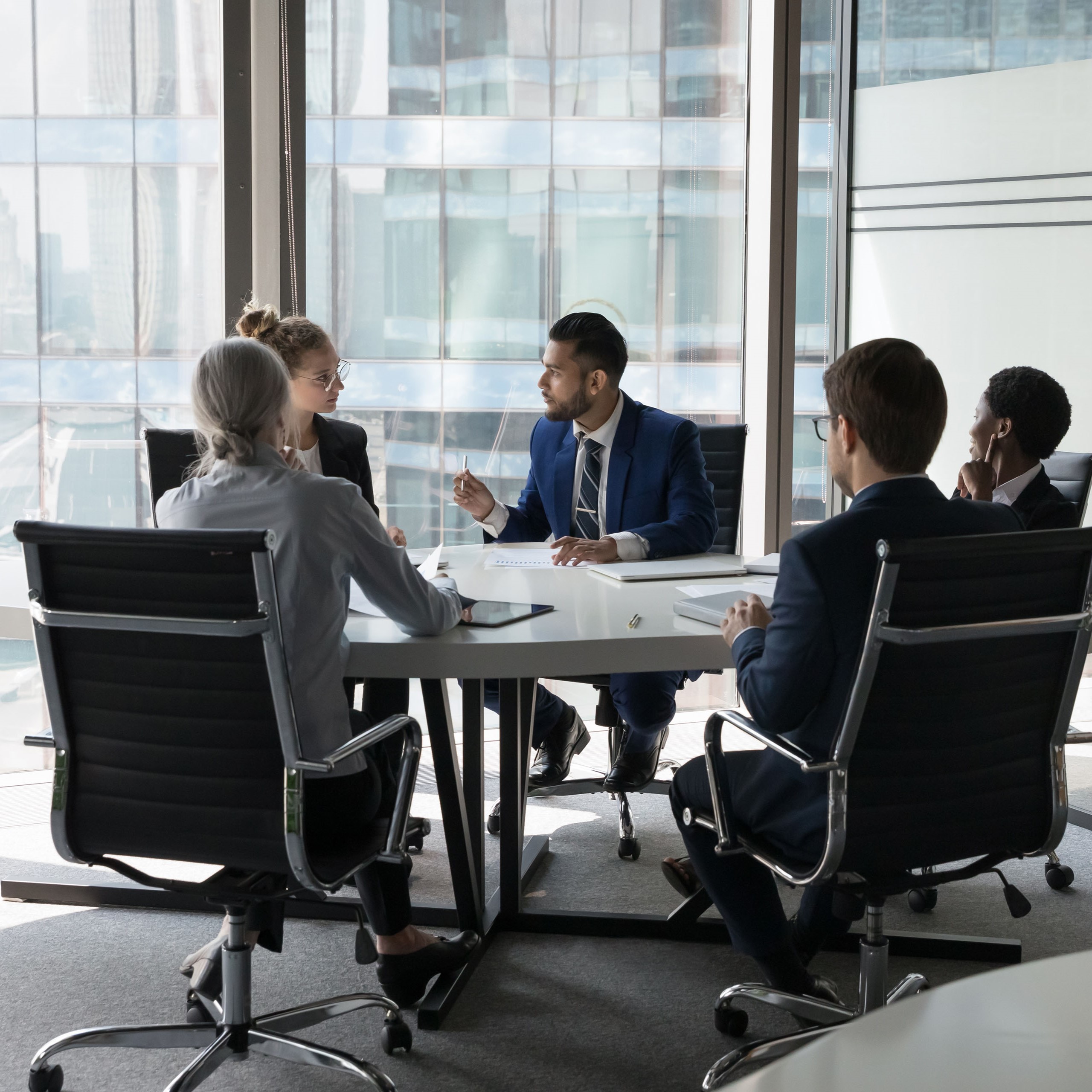 business people negotiating in modern boardroom business people negotiating in modern boardroom